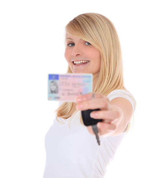 istock Young woman showing her drivers licence 115726984