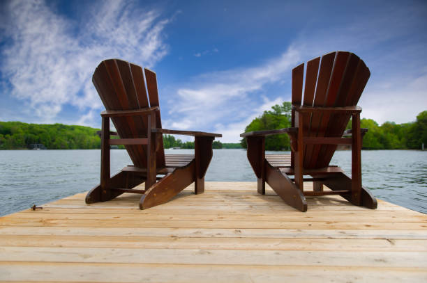 istock Two Adirondack chairs on a wooden dock 1157270380