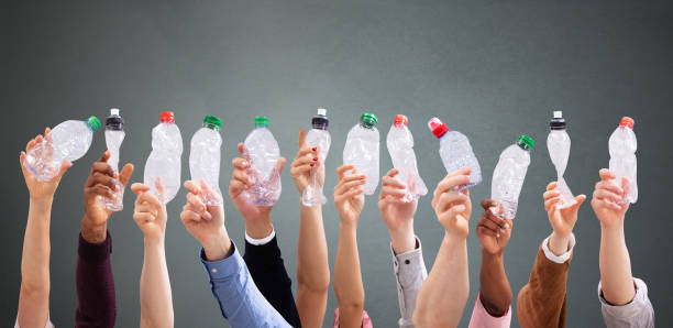 istock People Holding Crushed Water Bottles 1157270476