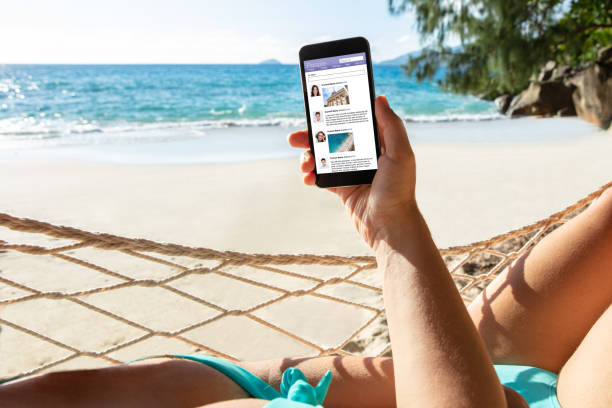 istock Woman Lying On Hammock Using Social App On Mobile Phone 1157270922