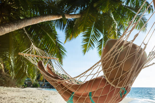 istock Woman In Bikini Lying On Hammock At Beach 1157270942