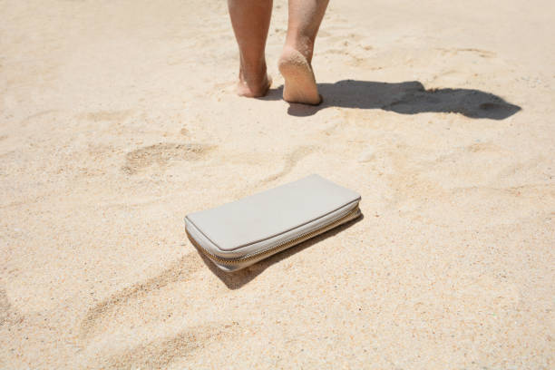 mujer caminando después de perder su bolso - lost beach fotografías e imágenes de stock