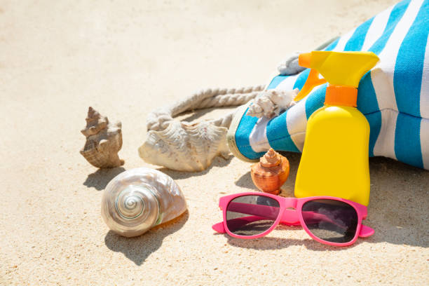 istock Sunglasses, Seashells And Handbag On Beach 1157273709