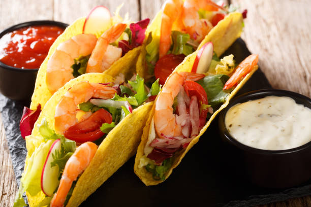 istock Crispy corn tacos with seafood fresh vegetables and sauces close-up. horizontal 1157274003