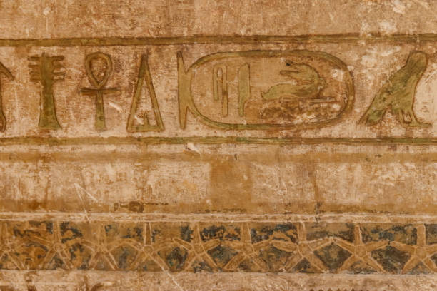 istock Ancient egyptian hieroglyphs carved on the stone wall 1157274624