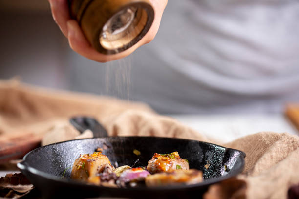 istock spreading ground pepper on baked pork chunk 1157277192