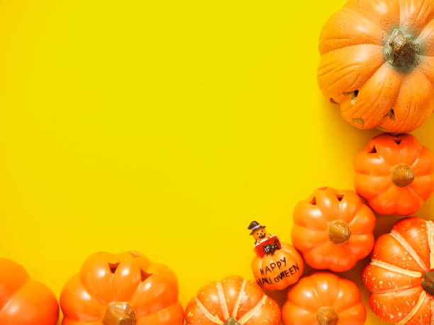 istock Halloween Banner decoration pumpkins frame on yellow background 1157277371