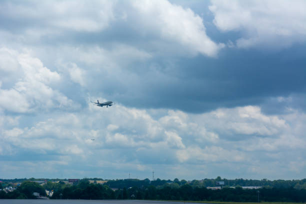 istock Airplane during Landing Operation on Partially Cloudy Sky Background 1157281969