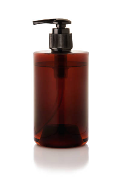 istock brown plastic  bottle with dispenser pumps isolated on white background with reflection 1157284378