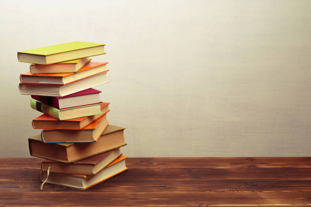 istock Stack of books on a wooden dest .Education. - Image 1157292938