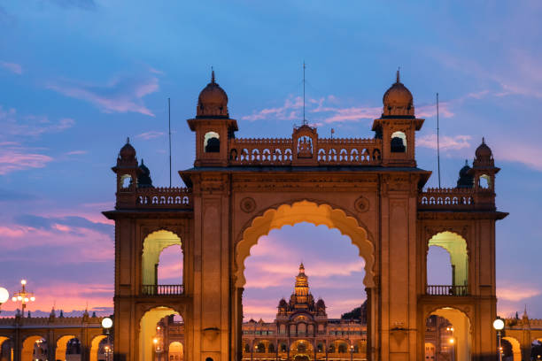 Illuminated front gate of Mysore palace, with Mysore palace in the background Illuminated front gate of Mysore palace, with Mysore palace in the background.This is a historical palace and a royal residence, Karnataka, India. mysore stock pictures, royalty-free photos & images