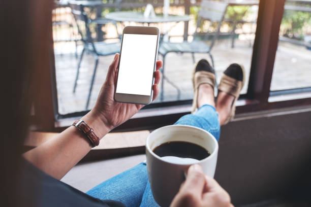 istock a woman holding white mobile phone with blank desktop screen 1157298096