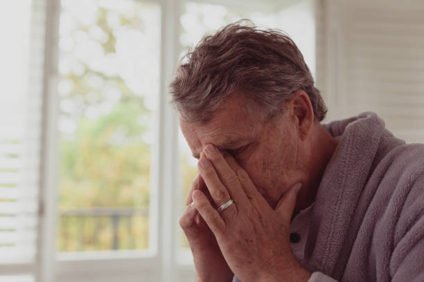 istock Sad active senior man with hands on face in a comfortable home 1157298101