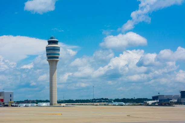 istock Control Tower at the Airport on Partially Cloudy Sky Background 1157298303