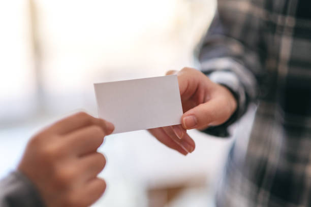 istock businessman holding and exchanging business card 1157298372