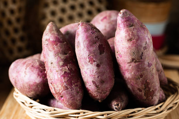 istock Sweet Potatoes Purple Colored on Table 1157299229