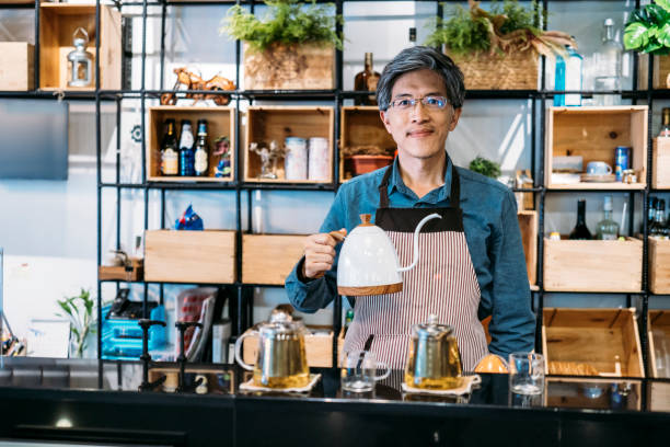 istock Asian man holding kettle and preparing tea 1157304945