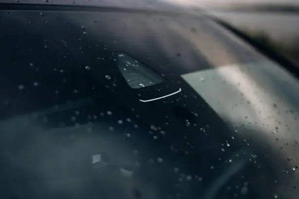 Rain and light sensor on the windshield of the car