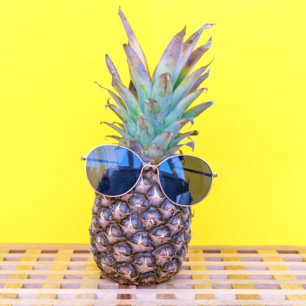 istock Pineapple wearing sunglasses on a yellow background 1157306503