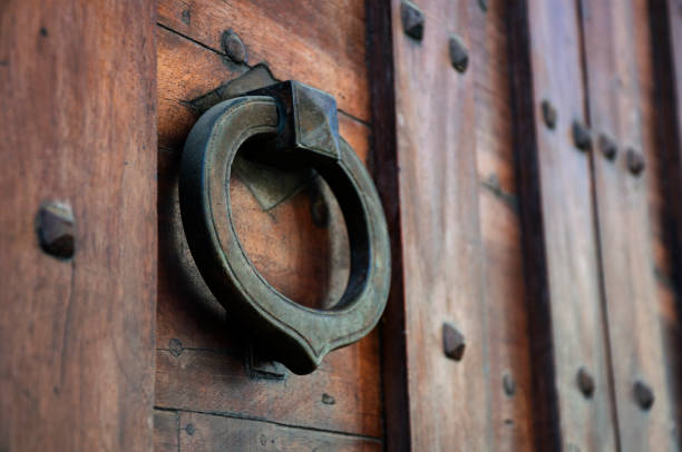 istock iron knocker on the old door in Italy 1157308324