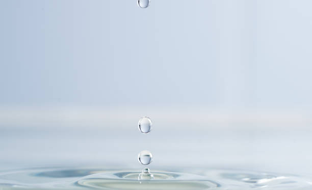 istock Splash from a drop of water on a light background macro 1157308339
