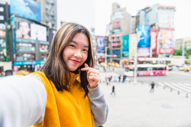 Young Taiwanese student in Ximen Taipei Horizontal color portrait image of a young Taiwanese woman in Ximen, Taipei, in Taiwan. vietnamese culture photos stock pictures, royalty-free photos & images
