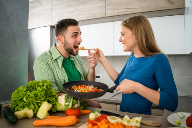 istock Couple making meal in their kitchen 1157309508
