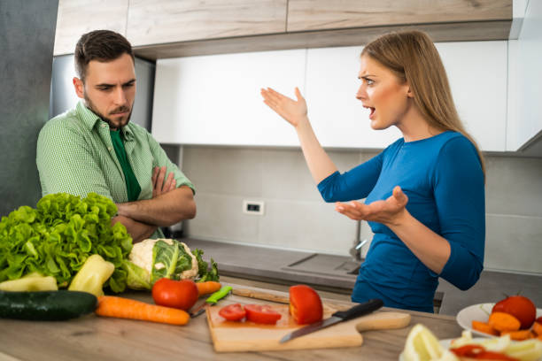 istock Couple making meal in their kitchen 1157311213