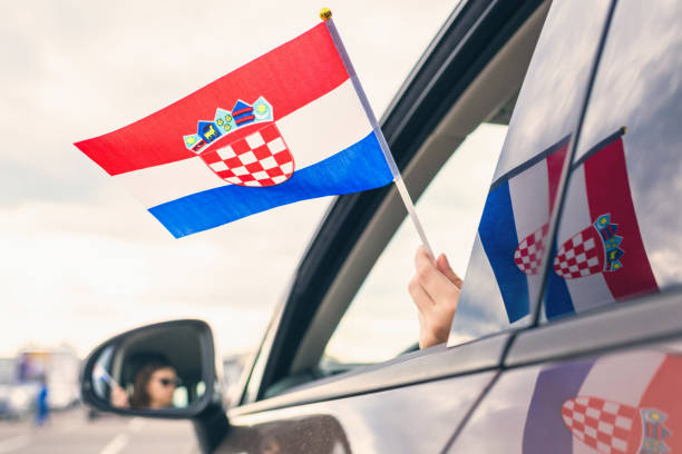 Woman or Girl Holding Croatian Flag from the open car window. Concept Woman or Girl Holding Croatian Flag from the open car window. Concept schengen agreement stock pictures, royalty-free photos & images