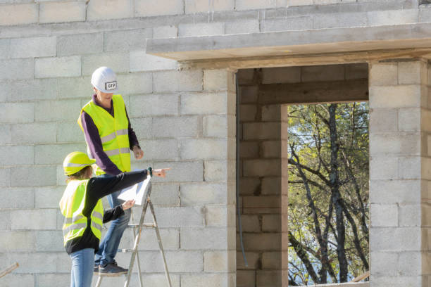 women working in construction, men's sector, gender equality - protective workwear bricklayer manual worker construction imagens e fotografias de stock