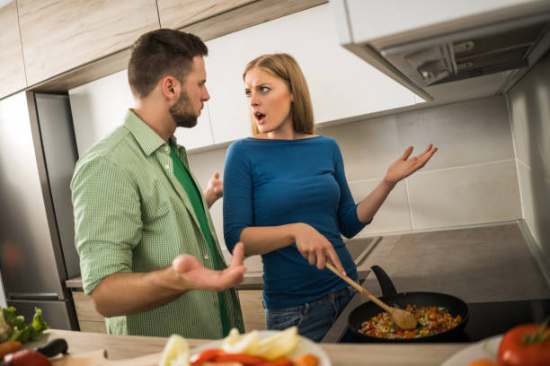 istock Couple making meal in their kitchen 1157312391