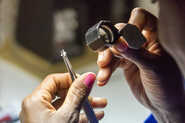 african woman worker Botswana, african woman worker checking quality of a diamond. jewelry craftsperson craft jeweller stock pictures, royalty-free photos & images