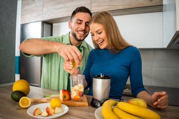 istock Couple making juice in blender 1157312750