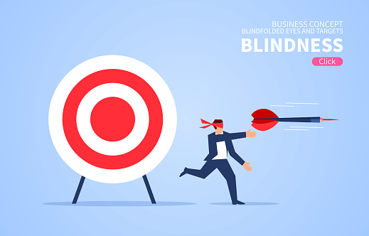 Blindfolded businessman using darts to shoot target