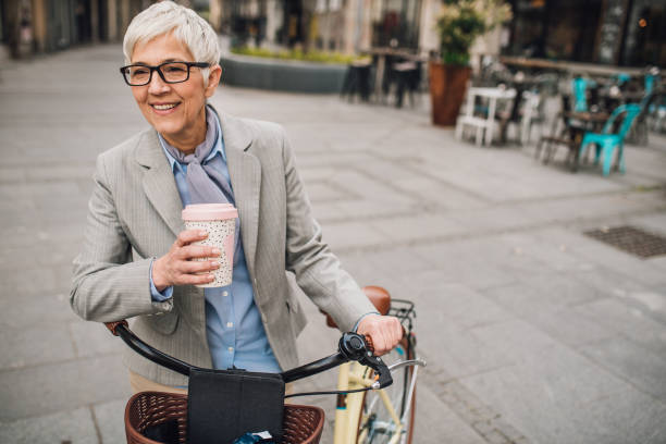 istock Happy old woman drinking coffee 1157315048