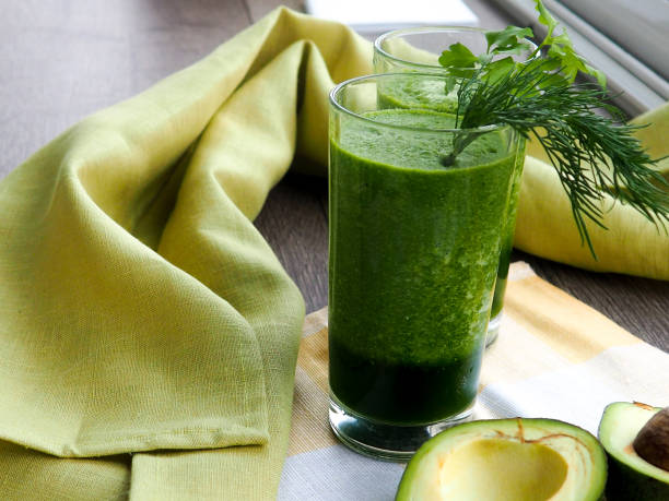 fresh avocado smoothie on gray background