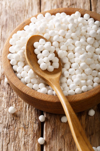 istock Dry pearl tapioca ingredient for cooking closeup in a bowl on a table. vertical 1157316548
