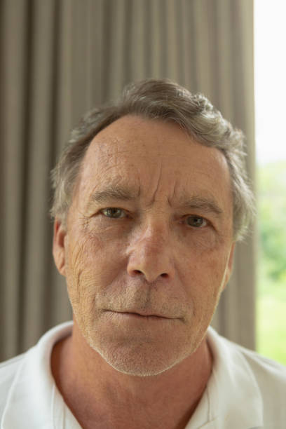 istock Active senior man looking at camera in a comfortable home 1157316679