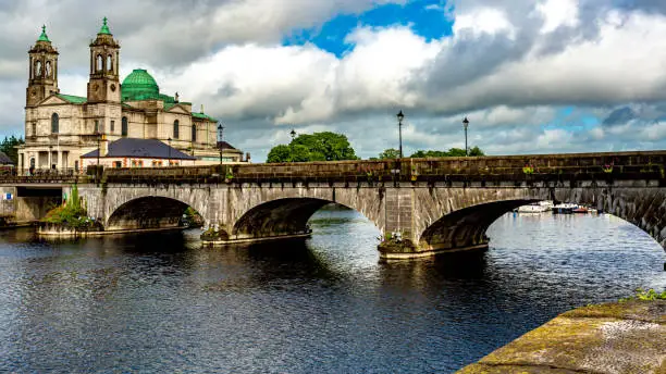 Beautiful view of the bridge over the river Shannon, the parish church of Ss. Peter and Paul with their green domes in Athlone town, wonderful quiet day in the county of Westmeath, Ireland