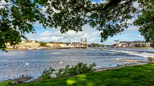 Beautiful view from a park of the river Shannon with the town of Athlone in the background, wonderful sunny day to enjoy in the county of Westmeath, Ireland