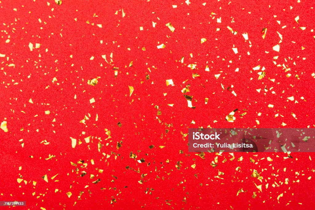 Golden Foil Confetti On Red Glitter Background Stock Photo - Download
