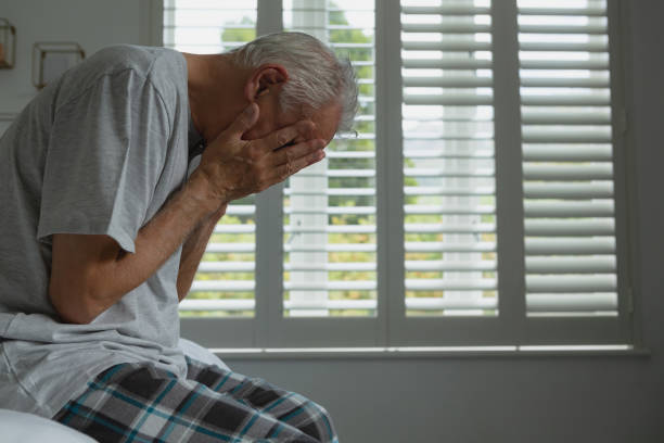 istock Active senior man covering face with hands in bedroom 1157320090
