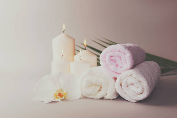 istock Three towels, candles and orchid flower. 1157320722