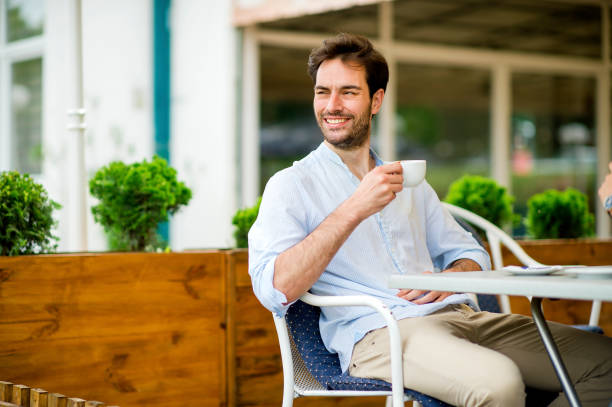 istock Young man enjoying his morning in coffee shop 1157320878