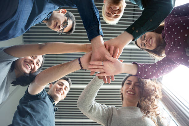 istock Coworkers putting their hands together 1157320986