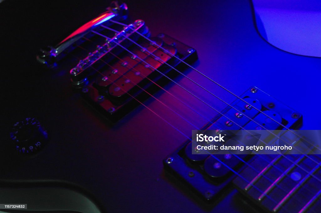 guitar body part Close-up electric guitar body part with gradient lighting effect. Acoustic Guitar Stock Photo