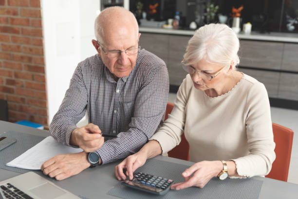 istock Senior couple paying bills together on laptop 1157325237