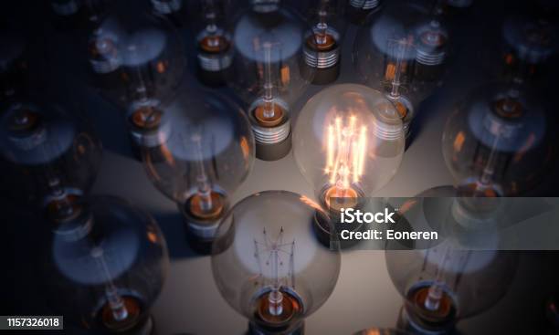 Glowing Light Bulb Standing Out From The Crowd Stock Photo - Download Image Now - Light Bulb, Leadership, Change