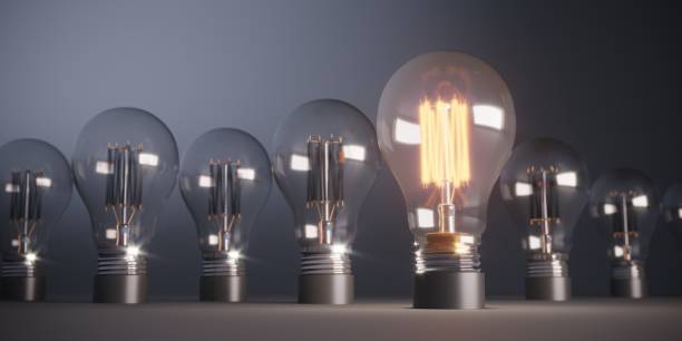 istock Glowing Light Bulb Standing Out From the Crowd 1157326288