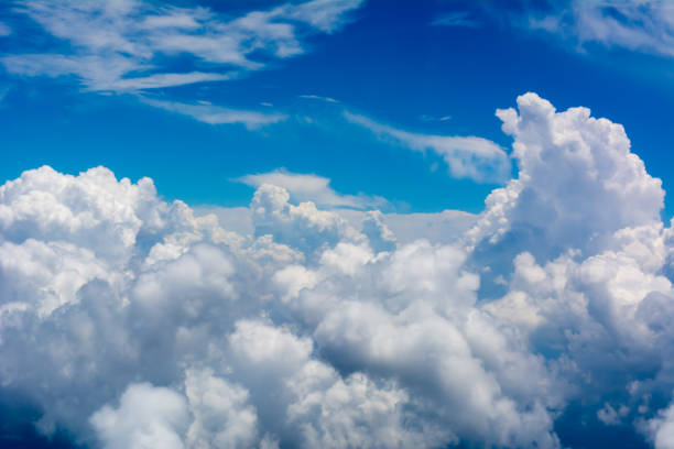 istock Puffy Clouds on Blue Sky Background taken from an Airplane in Flight 1157327276